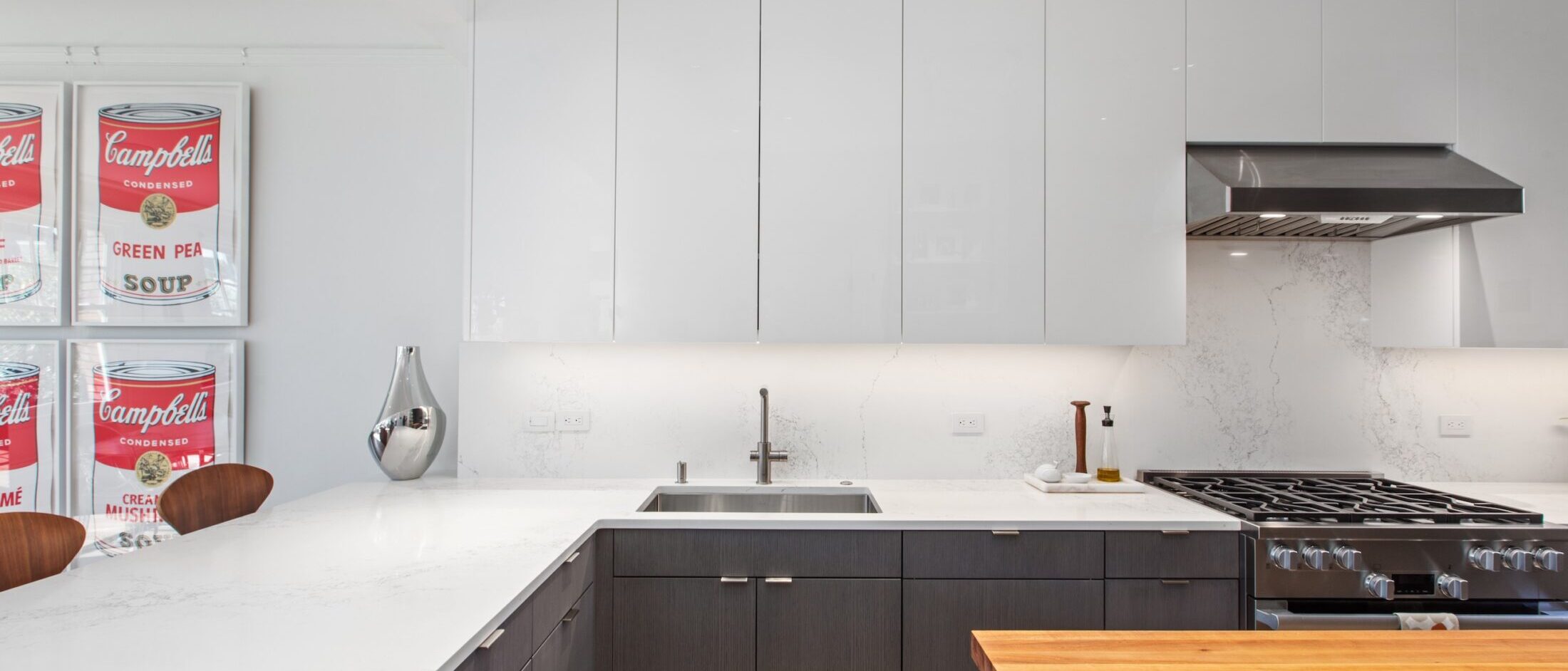 1830 Jackson #B – Kitchen Modern kitchen with white gloss cabinets, quartz backsplash and butcher-block island at 1830 Jackson #B, San Francisco