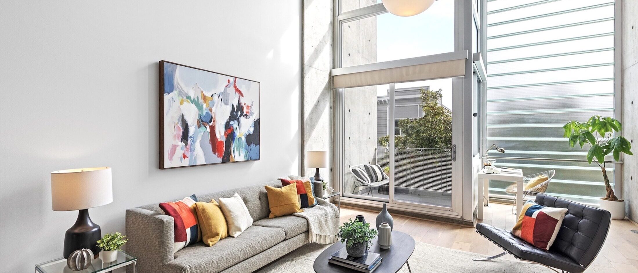Yerba Buena Lofts #311 – Living Room Two-story loft living room with floor-to-ceiling windows at Yerba Buena Lofts #311, 855 Folsom, San Francisco